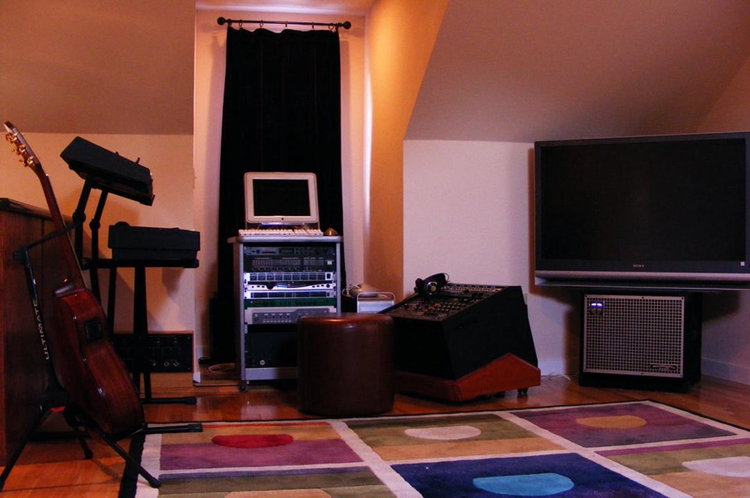 The midi room, upstairs. Replete with Pro Tools, an older G5, analog synth modules, analog synth controller (JP 8000) and Genelec 1030's for listening.
If we wish to track everyone live, the vocalist goes in the booth,