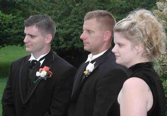 matthew , shane and sarah at matt's wedding watching the bagpiper's kilt lift in the wind !!!