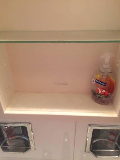 Test. See the slot in the center of the medicine cabinet, who knows what this is for?
