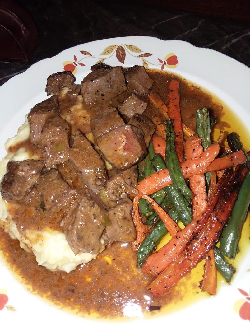 Tonights fare: Beef tips in a butter sauce over garlic mashed potatoes, with roasted green beans and carrots.