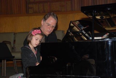 Sophia at her first piano recital, with organizer.