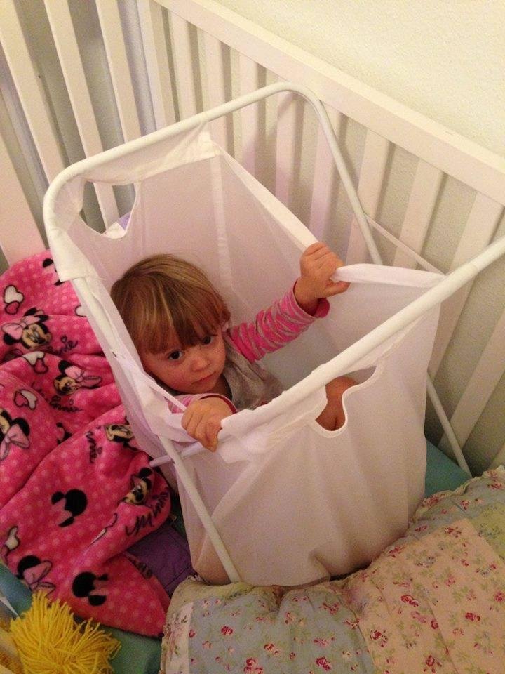 Miranda called us last night after going to bed. This is what we found. She pulled her laundry basket into her bed and climbed in. All was good until she couldn't get out.