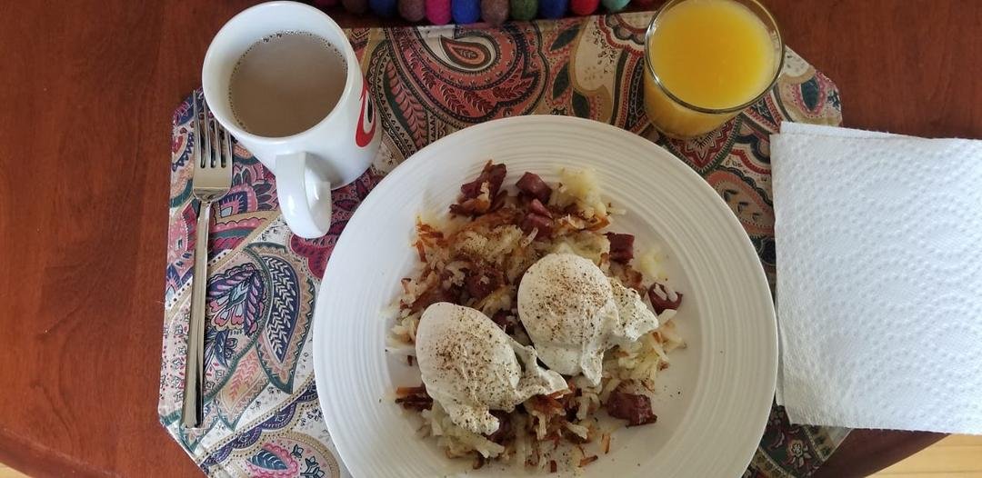 Corned beef hash browns and poached eggs with a mini mimosa and a Bailey's coffee.