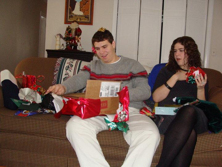 David is opening his surprise Chrsitmas gift. His football game jersey.