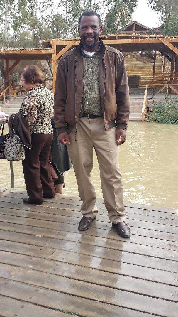 At the Jordan river in Israel/Palestine.  The Jordan river may be "chilly and cold" but it is not very deep or wide.