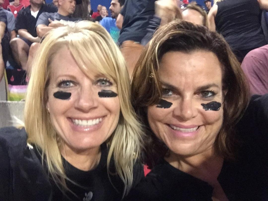 Trisa wearing the eye black at a night game.