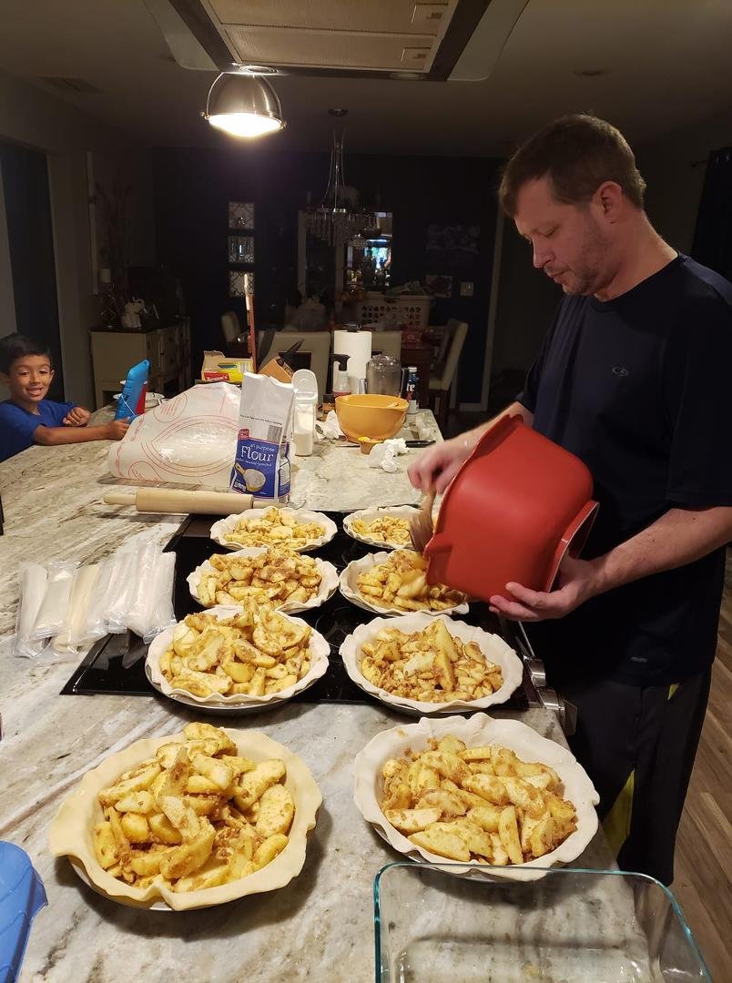John doing his annual apple pie project, notice maddox supervising on the side!