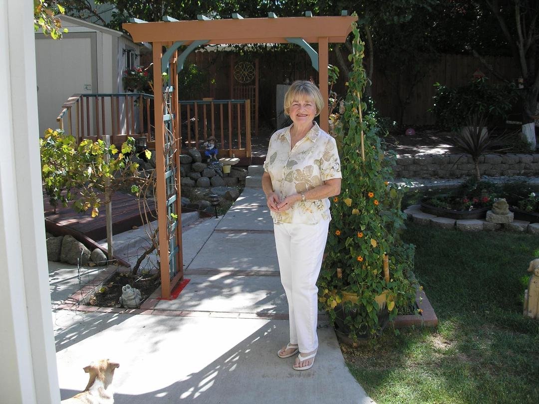 Gerrie standing in the Back Yard of the House.