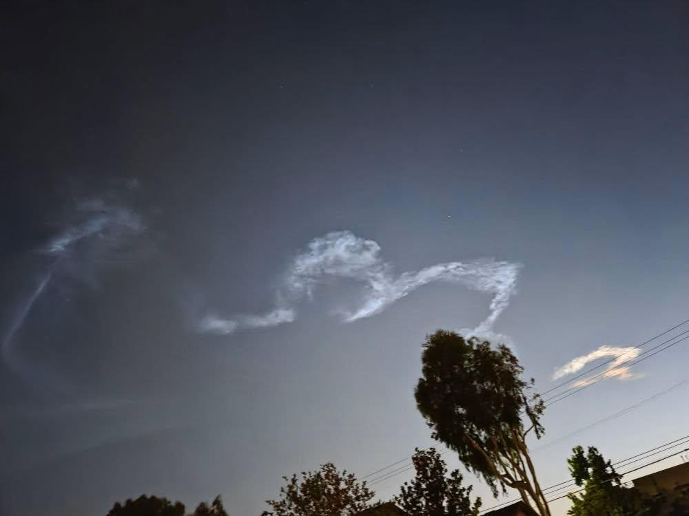 These aren't clouds and Casey said she saw something that looked like an incoming rocket or something.  It's possibly unconnected because I saw this when I came out of the back of the house and she was in front when she saw