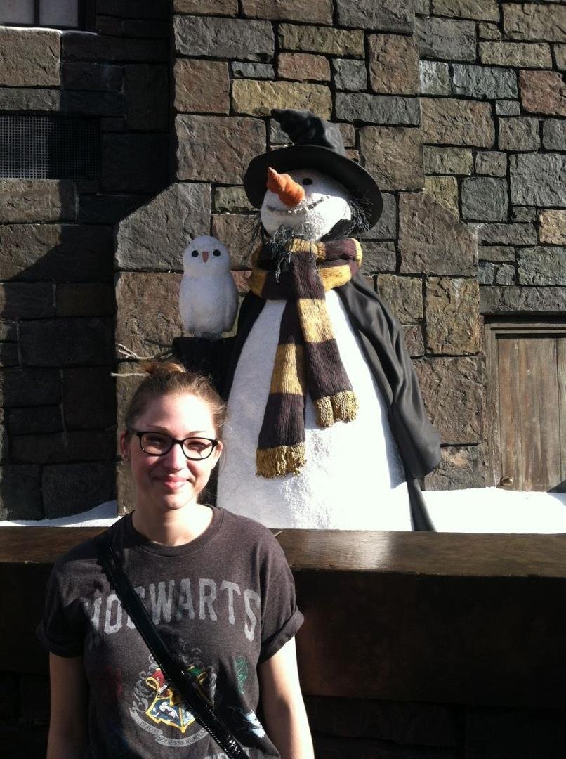 Erin posing near cute snowman.