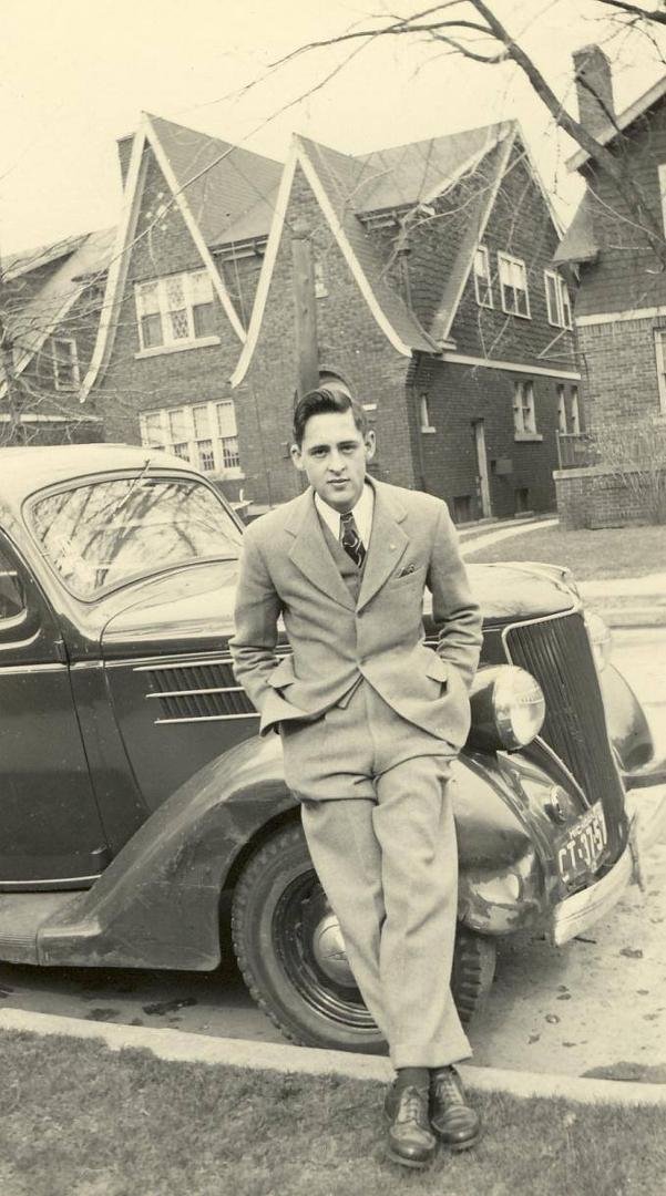 My dad at 20 with his beat up old Dodge.