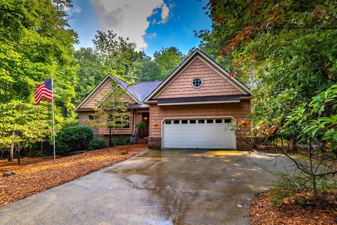 How about the greatest location golf course home in prestigious Connestee Falls Subdivision. FLAT driveway; home on 4th tee of the George Cobb designed championship golf course. Easy stroll to Lake Atagahi.  3BR 3.5 Bath.  