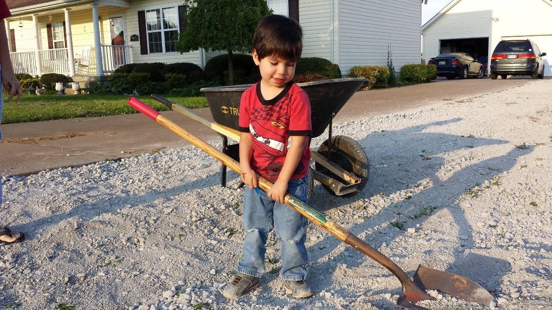 My grandson, Caden, helping us spread gravel.