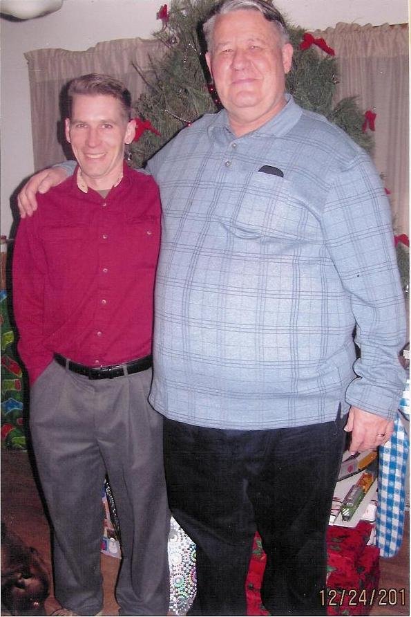 Christmas tree in the background has a train under it.