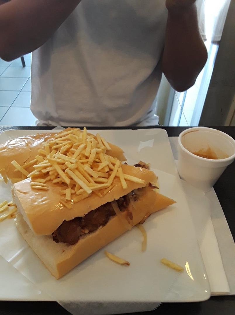 Lechon. Yummy. Josh Young loving that sandwich and his Cuban coffee!