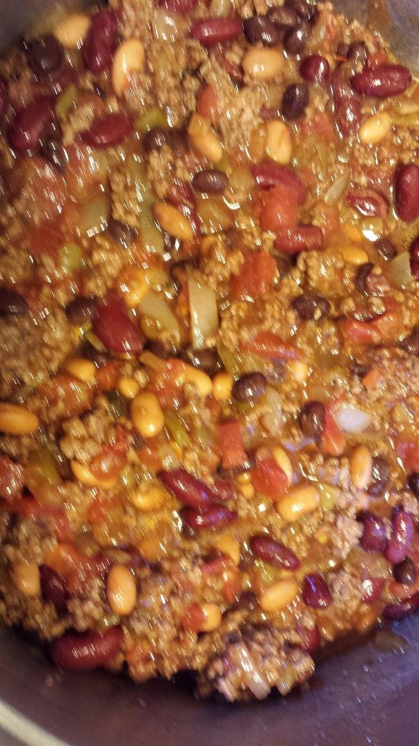 Smelling sooooo good the neighbors are chanting in the front yard "We want chili - we want chili" with their bowls in their hands beating on them with their spoons! And yes Melanie is helping!