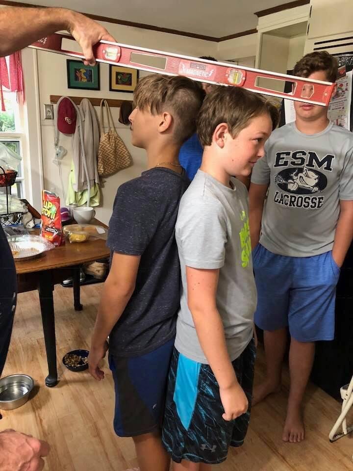 Two youngest grandsons trying to decide who is the tallest. Noah for sure!