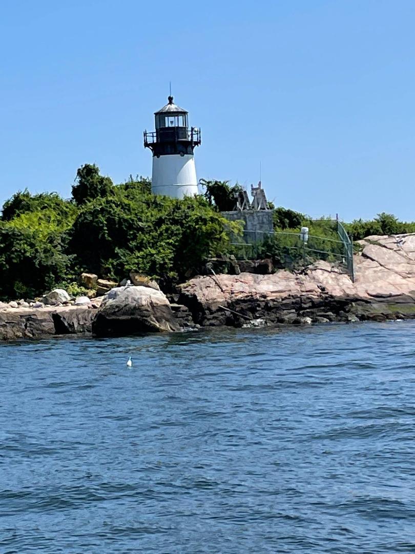 The lighthouse on 10 Pound Island in Gloucester Harbor, on a beautiful summer day.