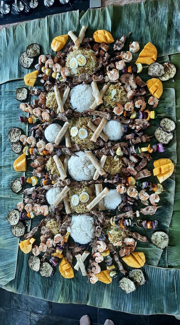 This is a real Filipino Easter feast. Thank you Gen, Shalen, Angelina and Rem. Filipino pancit, rice, pork skewers, shrimp skewers, lumpiia, fried pork, fried pork belly, eggplant and mango presented on banana leaves.