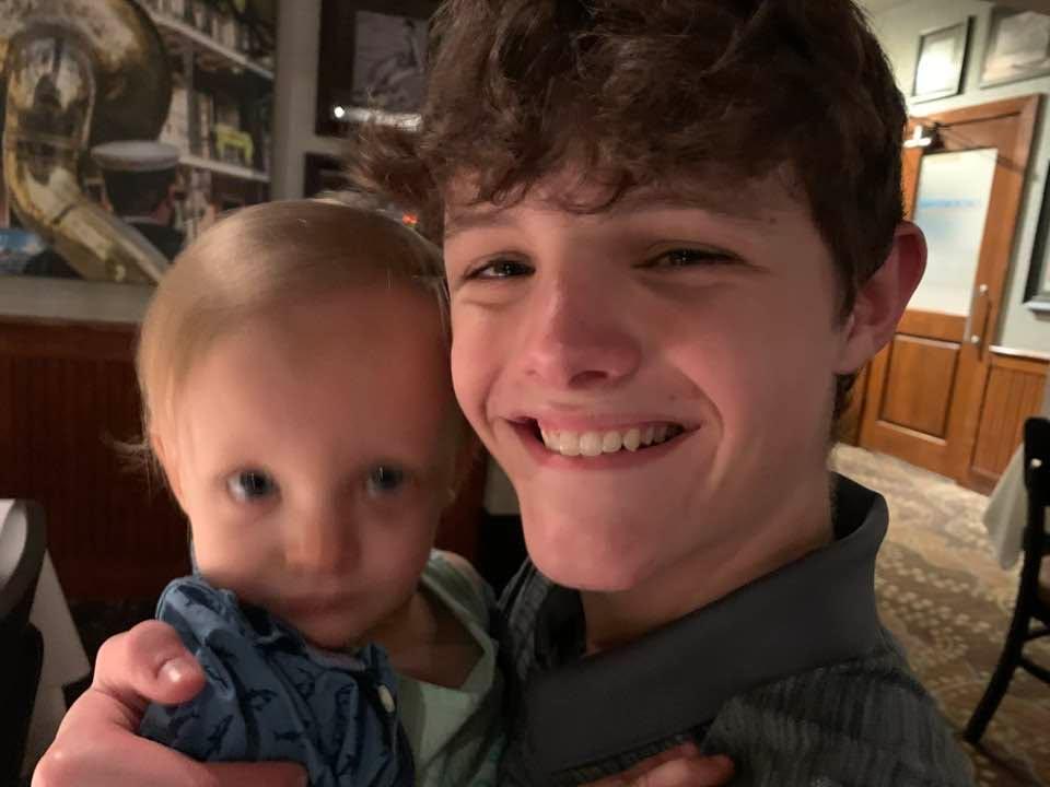 Grandson Sean with baby brother Jax, at his 13th birthday family dinner. ❤️ Jax didn’t quite know what to think of me and my camera.