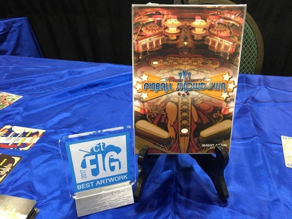 Just wanted to share what happened at the Connecticut Festival of Indy Gamers yesterday. My lovely wife won the best art award for her work on Pinball Showdown (with Matthias Bonnici running layout). This award is pretty am