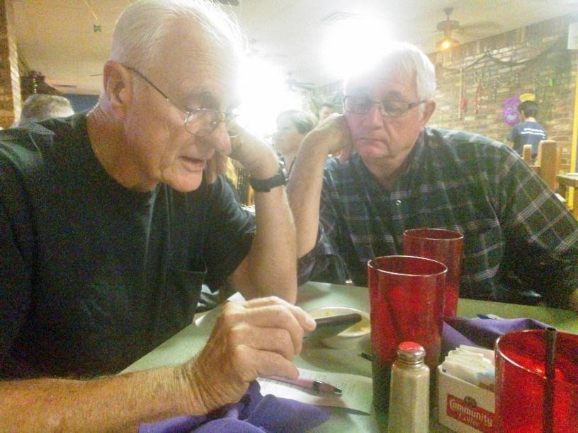 Out to dinner at Boo Rays with our "romantic" husbands. John & Bob are watching the TCU-Baylor football game on John's phone.