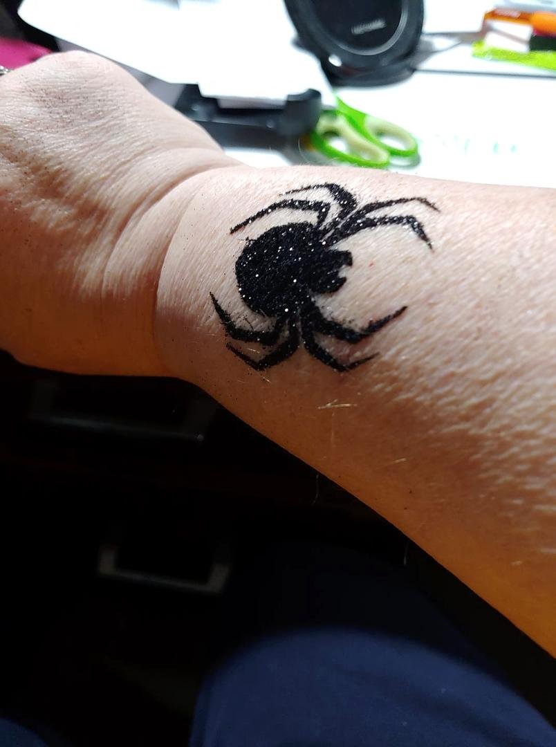 My very first tattoo....yes it's only glitter but spiders are my biggest fear...should have suspected something was up when the grandkids blindfolded me