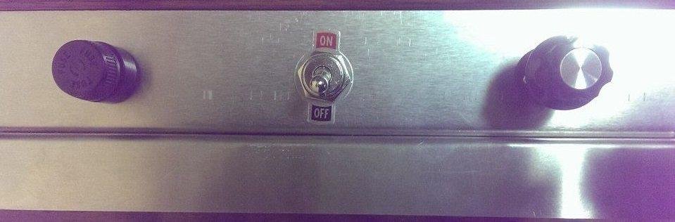 Front View - Fuse on the left, on off switch in the middle and variable light control on the right.