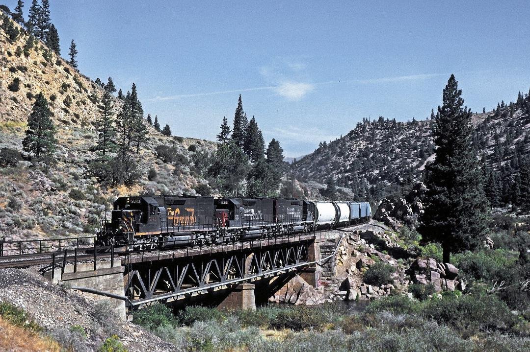 First weekend in September 1996, the last one in the Espee's existence,
Rio Grande SD40-T2 #5343 leads two other former D&RGW  T2's West crossing the Truckee River at Mystic(?) with a loaded grain train.