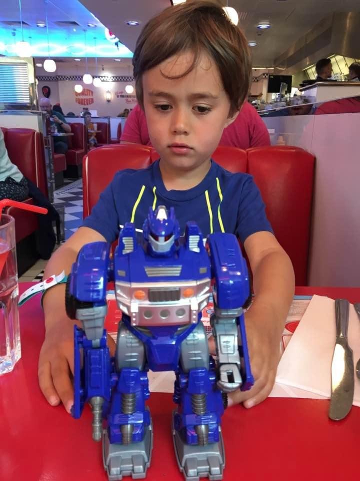 Playing with his robot at Ed's Diner waiting for lunch.