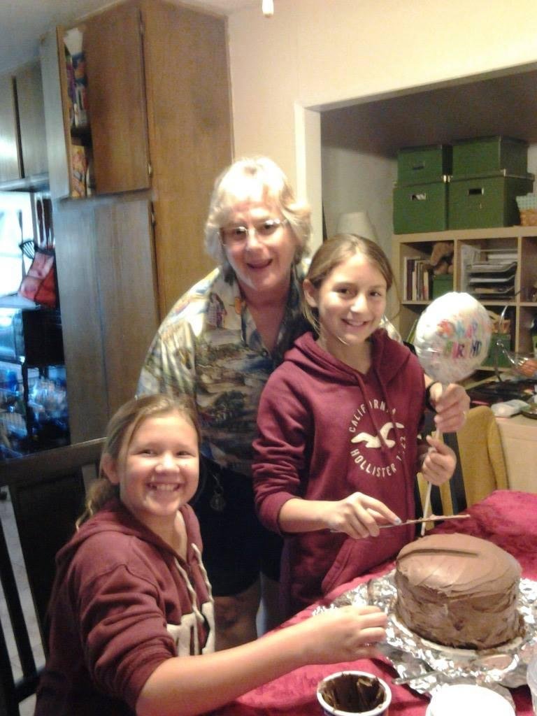 Destiny, MacKenzie & me. The girls are decorating the birthday caje.