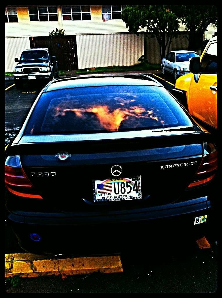 Reflection from an evening sky over waianae onto a car's back glass, what image do you see?