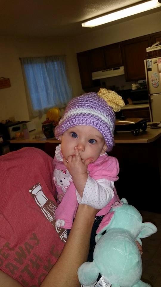 My youngest granddaughter and her new hat made by her 16 year old sister in 2 hours.