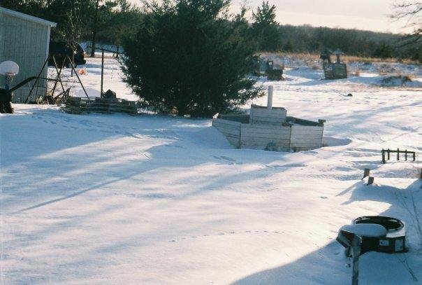 Snow drifts halfway up my raised garden and the air conditioner.