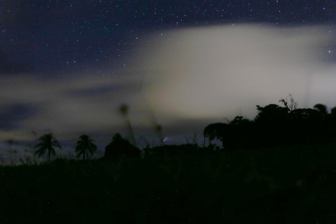 Hey, I finally saw comet NEOWISE tonight from Kauai after getting out of the mandatory 14 day quarantine. Of course we had clouds around and I didn't have a tripod, but I improvised. Here's my image with some image proces