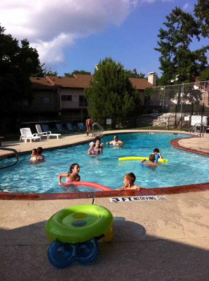 Kids swimming in the pool.