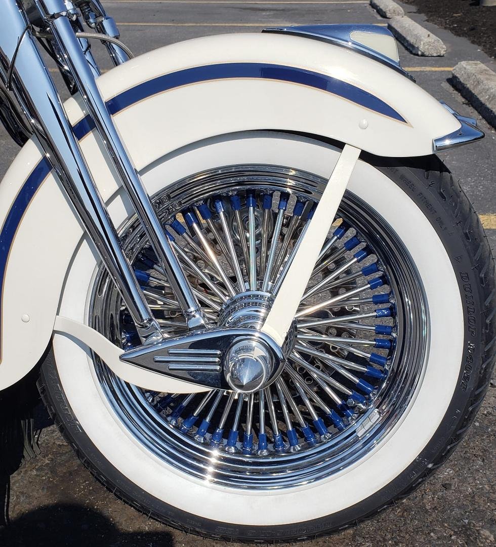 Check out this fat spoke wheel that I had custom made for my 97 Springer. Notice the collor match on the spoke nipples to the blue stripe. Very happy
