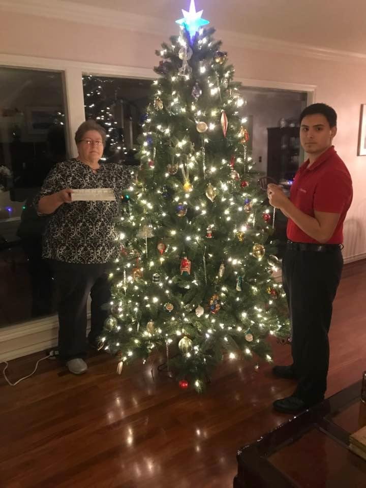 Grandma and grandson Christopher putting the finishing touches on the tree.