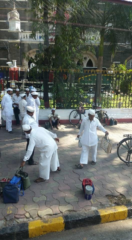 100s of men who daily deliver lunches to working men.  Their wives have made the lunches and they are picked up in their homes and put on trains to central Mumbai where another set of men pick them up and deliver by bikes t