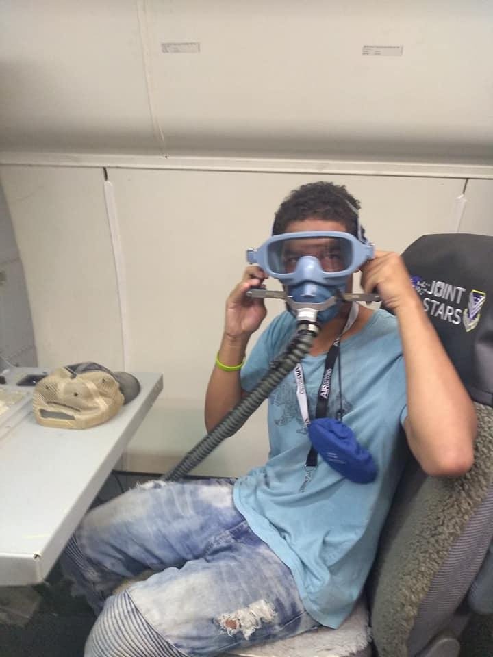 Chris sitting in his grandpa's old work desk on board the E-8C