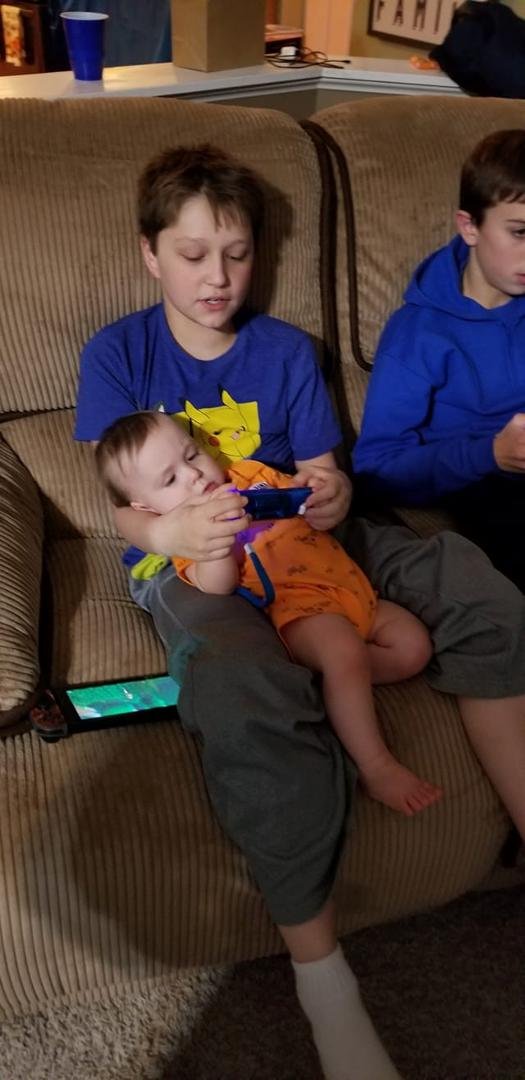 Brayden teaching his little brother to hang with the big kids at his party.