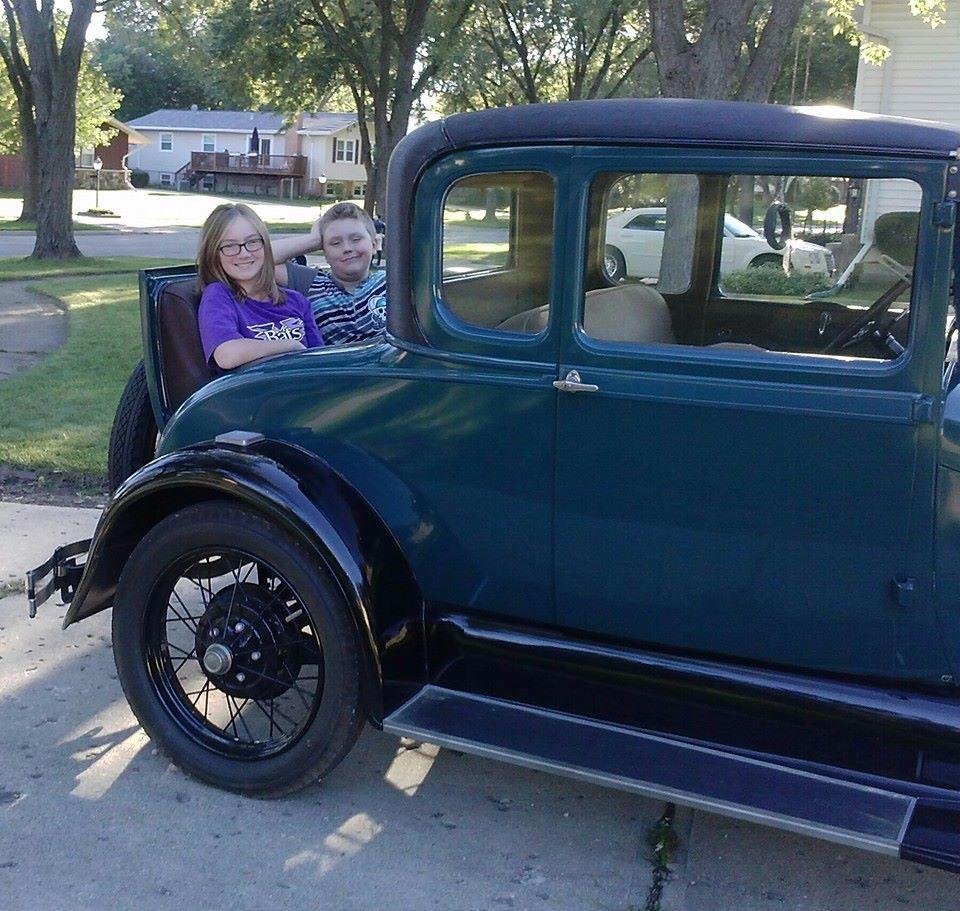 My wonderful grandkids enjoying a ride. It is great to have my old car back on the road.