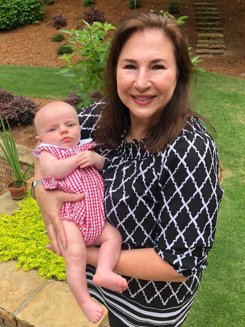 Debi with Henry in the backyard after a fun day by the pool.