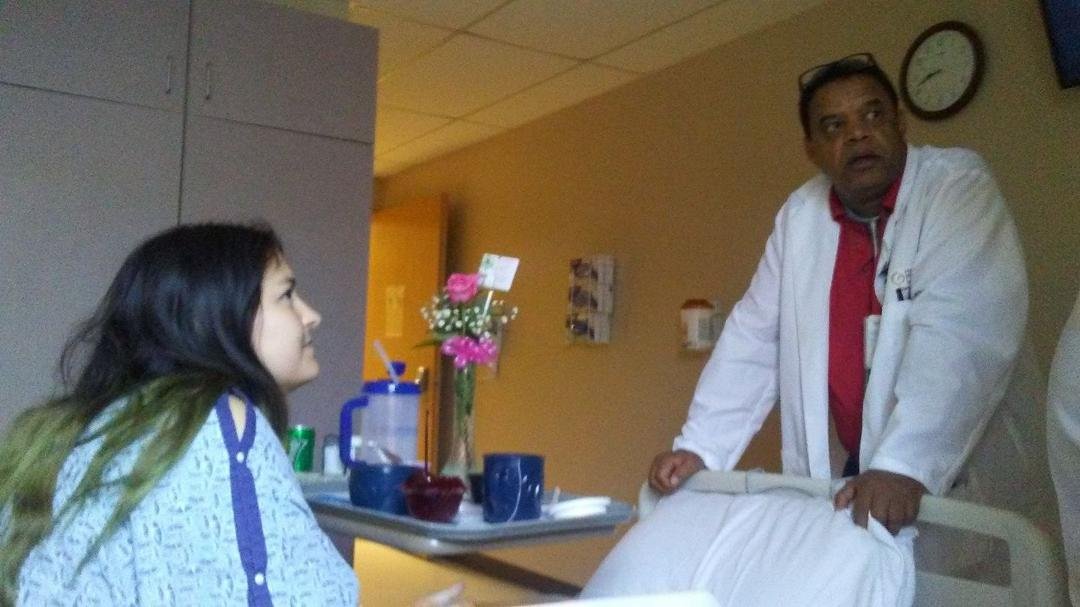Shawna talking to the doctor after a successful surgery. In four to six weeks another surgery to be performed with all the ice-cream she can eat
