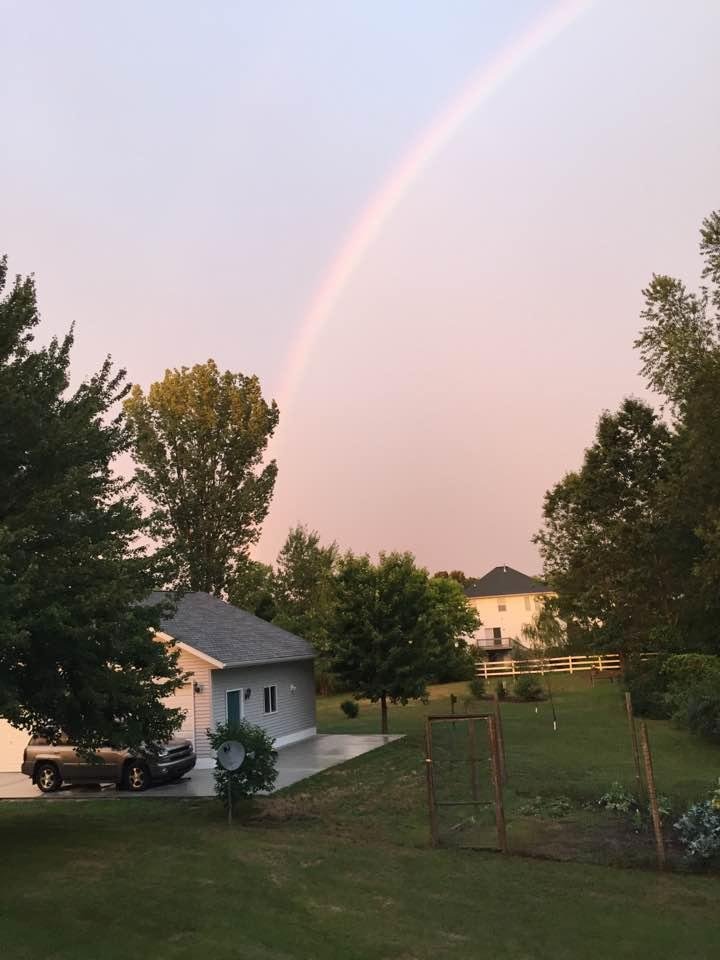 Couldn't resist taking this photo. After a recent rain shower a rainbow appeared overhead. Appropriately the end of the rainbow is over MY GARAGE!! It's a guy thing.