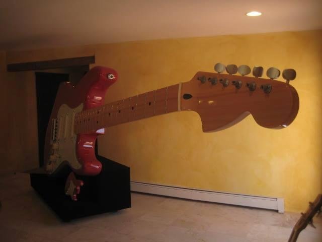 This is a 16' long Stratocaster. Notice the life size Fender Stratocaster sitting at the base of the stand. It's 99% finished.