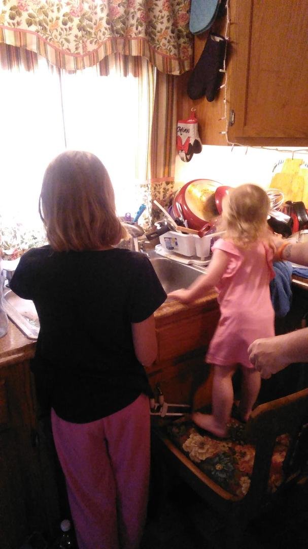 Tristyn Duha and Olivia washing dishes