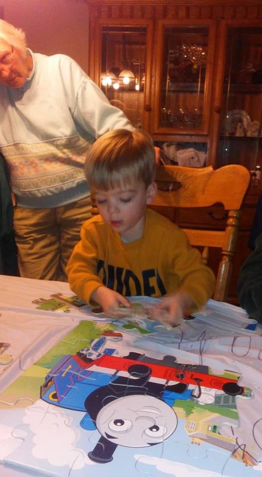Henry doing his Thomas puzzle with grandma Smith looking on.