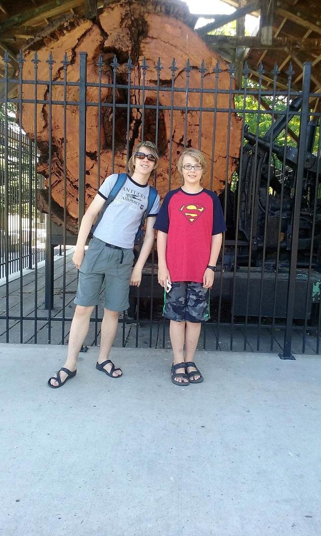 Leif-Eirik and Richard in front of a giant log.