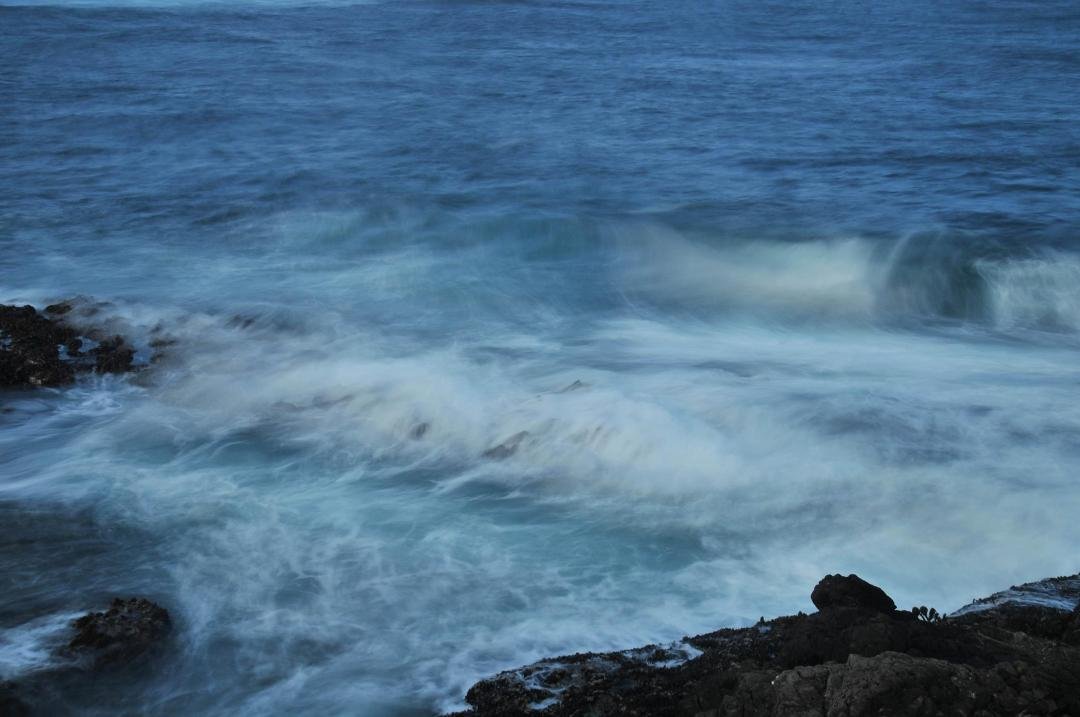 A shorter exposure time, one-tenth of a second, to capture some detail in the waves ricocheting off the rocks.